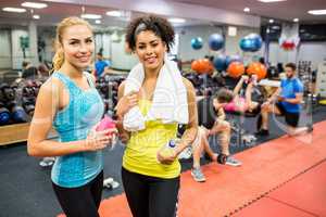 Fit women chatting in weights room