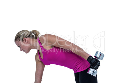 Muscular woman exercising with dumbbells