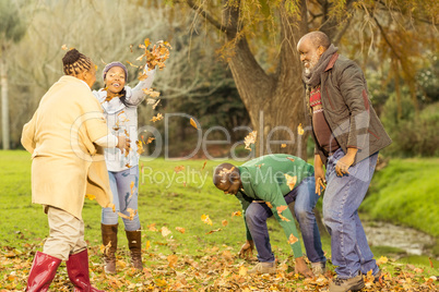 Happy family throwing leaves around