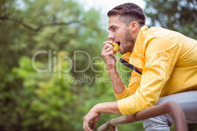 Fit man eating an apple