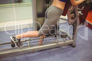 Fit woman using exercise equipment