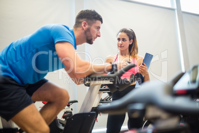 Trainer timing man on exercise bike