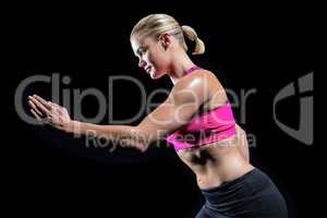Muscular woman running in sportswear