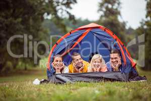 Happy friends lying in their tent