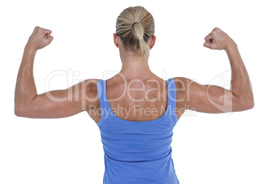 Rear view of woman flexing muscles