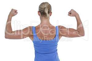 Rear view of woman flexing muscles