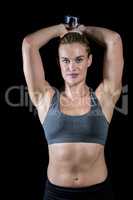 Muscular woman lifting heavy dumbbells