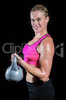 Muscular woman lifting heavy kettlebell