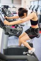 Exhausted woman on the exercise bike