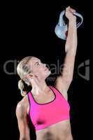 Muscular woman lifting heavy kettlebell