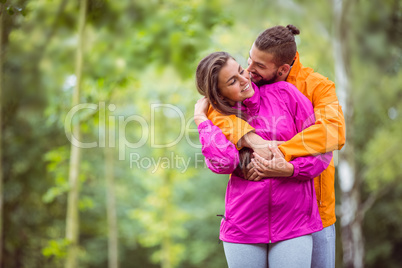 Happy couple hugging on hike