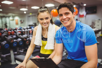 Trainer and client discussing her progress