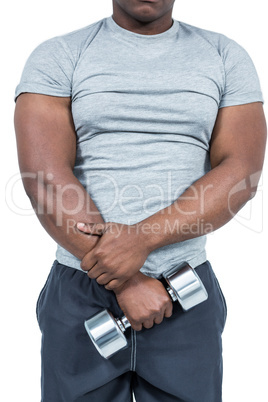 Fit man exercising with dumbbell