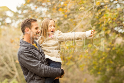 Cute little girl showing her father something