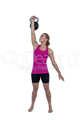 Muscular woman exercising with kettlebell