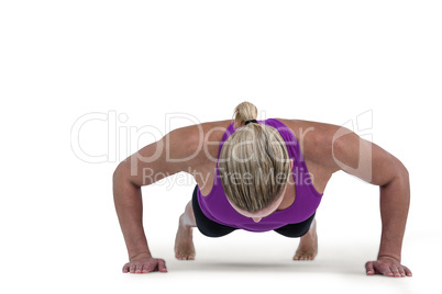 Muscular woman doing push ups