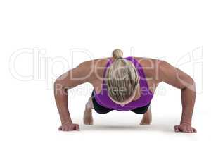 Muscular woman doing push ups