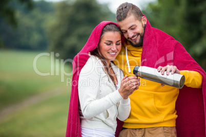 Happy couple under a blanket