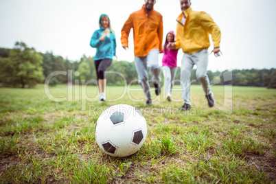 Friends running towards football