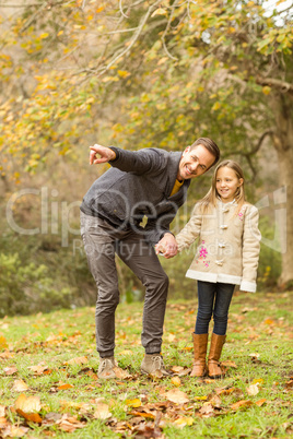 Happy father showing something to his daughter