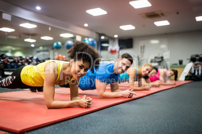 Fit people working out in fitness class