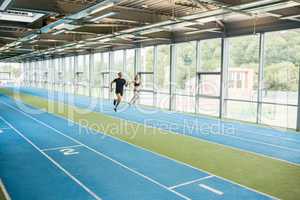Couple running on the indoor track