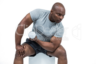 Fit man exercising with dumbbell