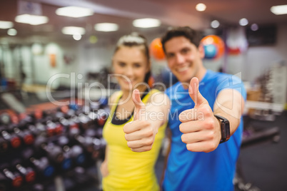 Fit couple smiling at camera