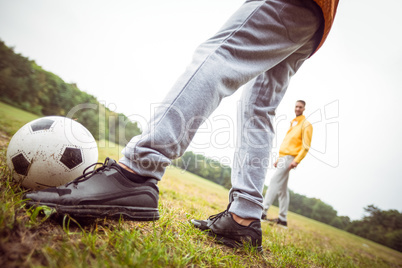 Friends playing football in the park