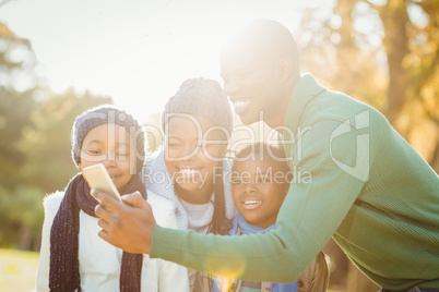 Young smiling family taking selfies
