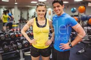 Fit couple smiling at camera