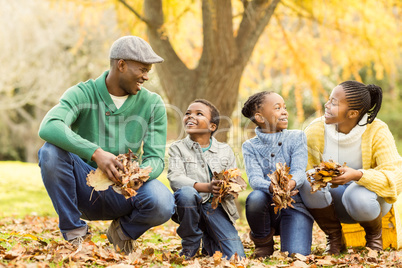 Portrait of young family holding leaves