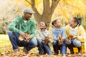 Portrait of young family holding leaves