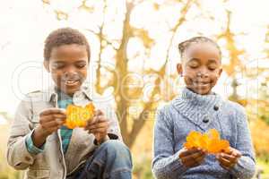 Portrait of young children holding leaves