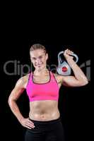 Muscular woman lifting heavy kettlebell