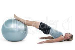 Muscular woman lying on floor with legs