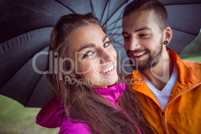 Happy couple under an umbrella