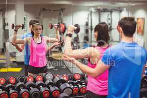 Fit couple working out in weights room