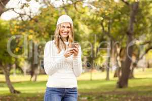 Portrait of a smiling pretty woman texting