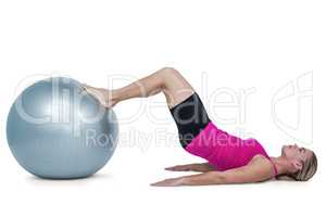 Side view of woman exercising with ball