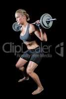 Muscular woman lifting heavy barbell