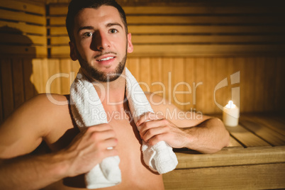 Man sitting inside a sauna