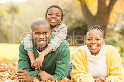 Portrait of a young family lying in leaves