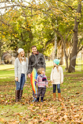 Young family playing with a kite