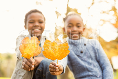 Portrait of young children holding leaves Portrait of young children holding leaves