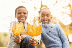 Portrait of young children holding leaves