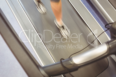 Fit woman jogging on treadmill