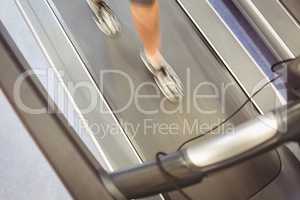 Fit woman jogging on treadmill