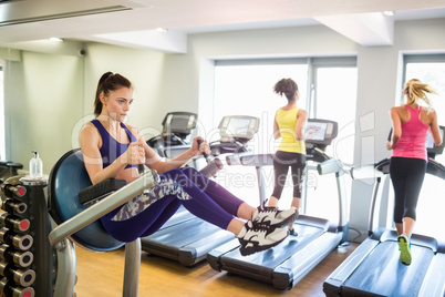 Fit people working out using machines