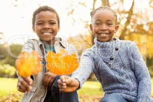 Portrait of young children holding leaves